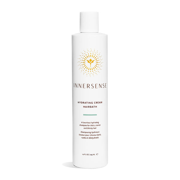 Full size 10oz bottle shown on white background, the packaging is a slim white bottle with a flip top and the label shows the Innersense gold flower logo with dots around it. 